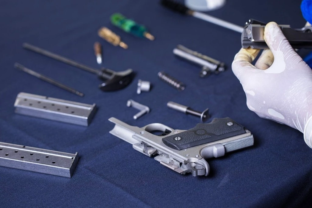 Gunsmith working on a firearm at the service bench